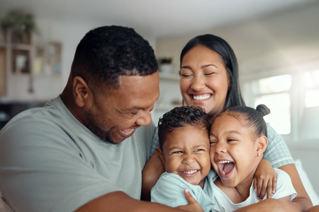 A family of 4 hugging each other