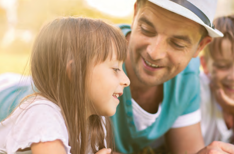 Dad and kids outdoors in golden light