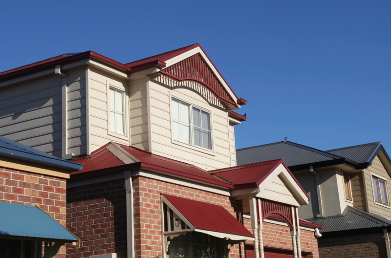 Suburban houses set against a blue sky
