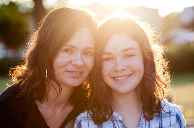 A parent smiling with her child. 