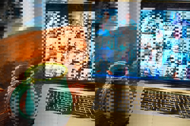 A person on a video call through their laptop talking with another person. 