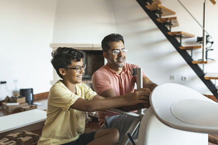 A father and son putting together a desk chair
