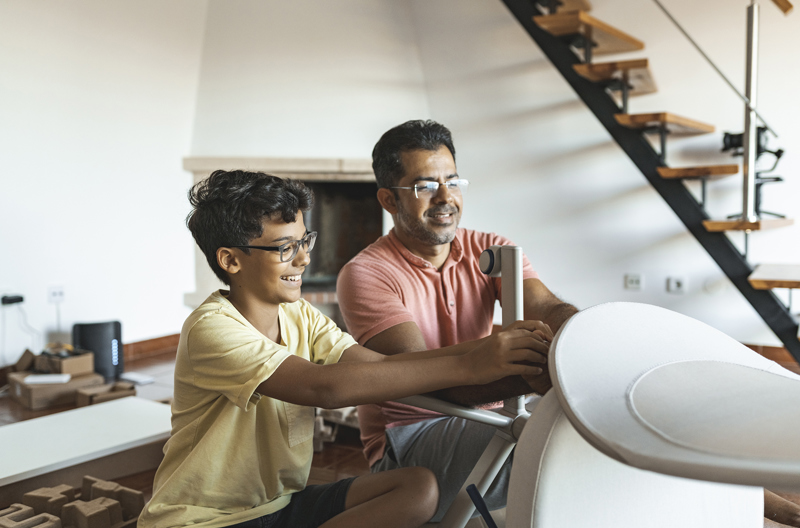 A father and son putting together a desk chair